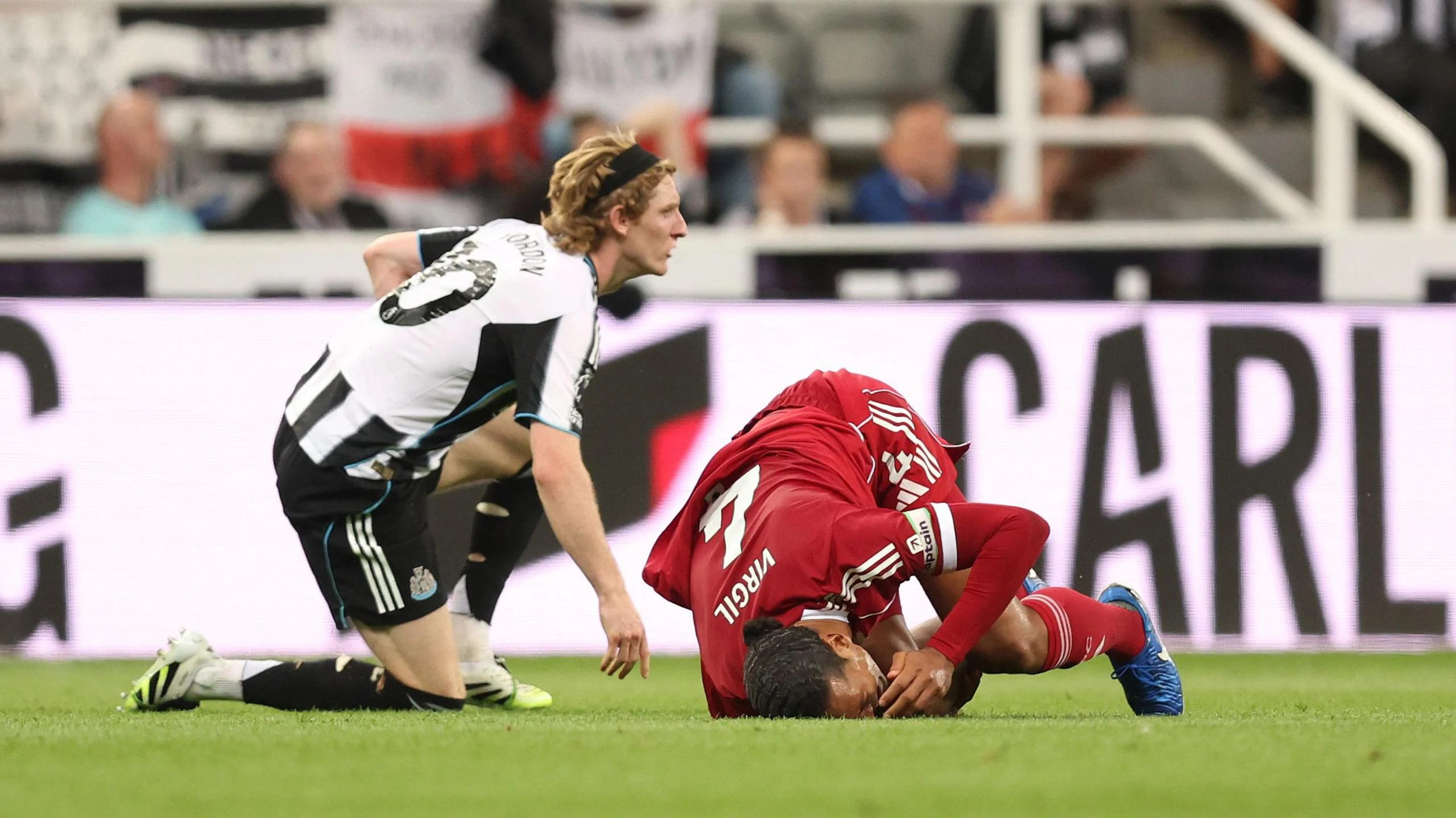 Anthony Gordon fouls Virgil van Dijk