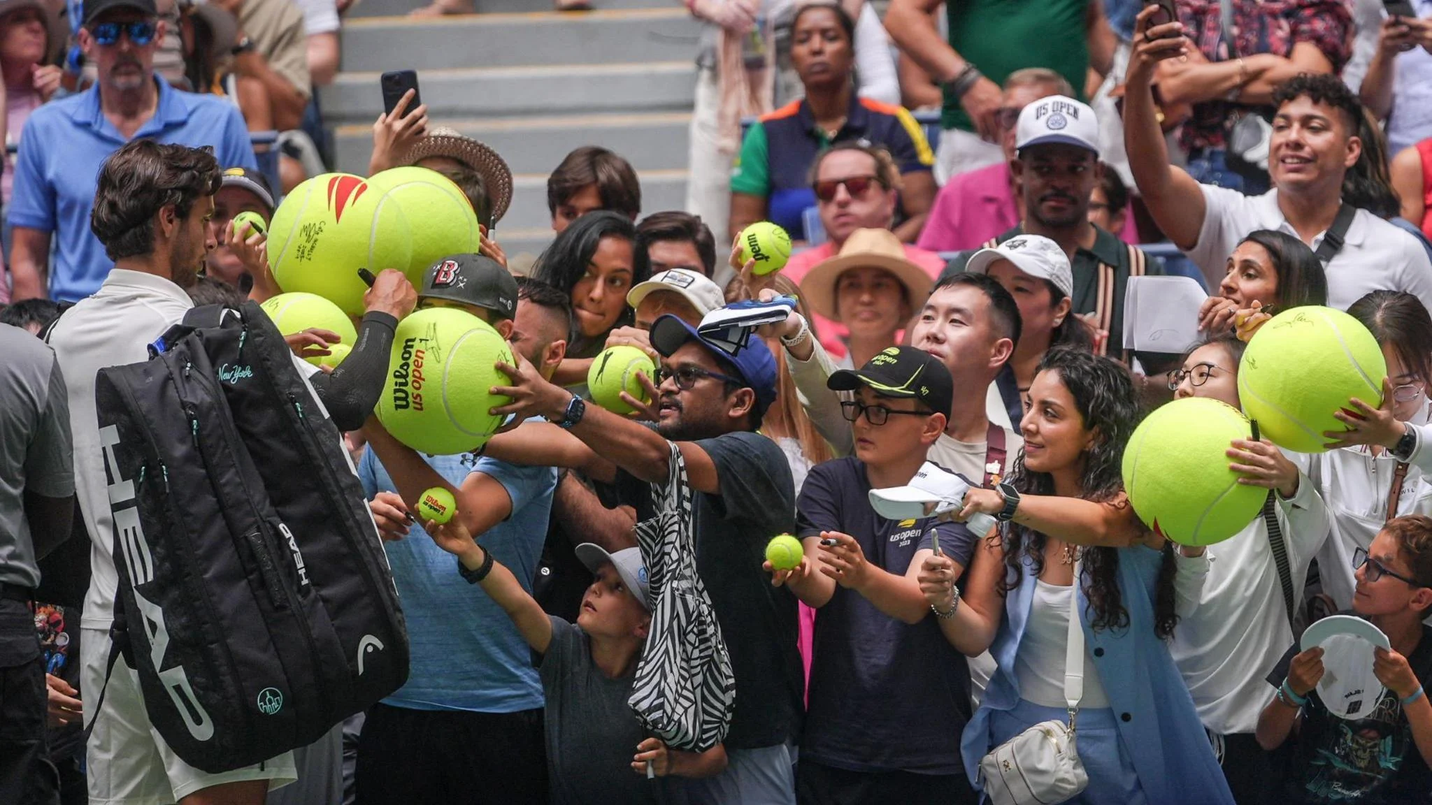 US Open fans wait as Lorenzo Musetti signs autographs