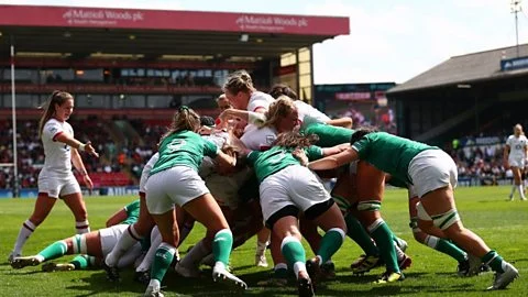 Players from England and Ireland take part in a maul on the rugby field