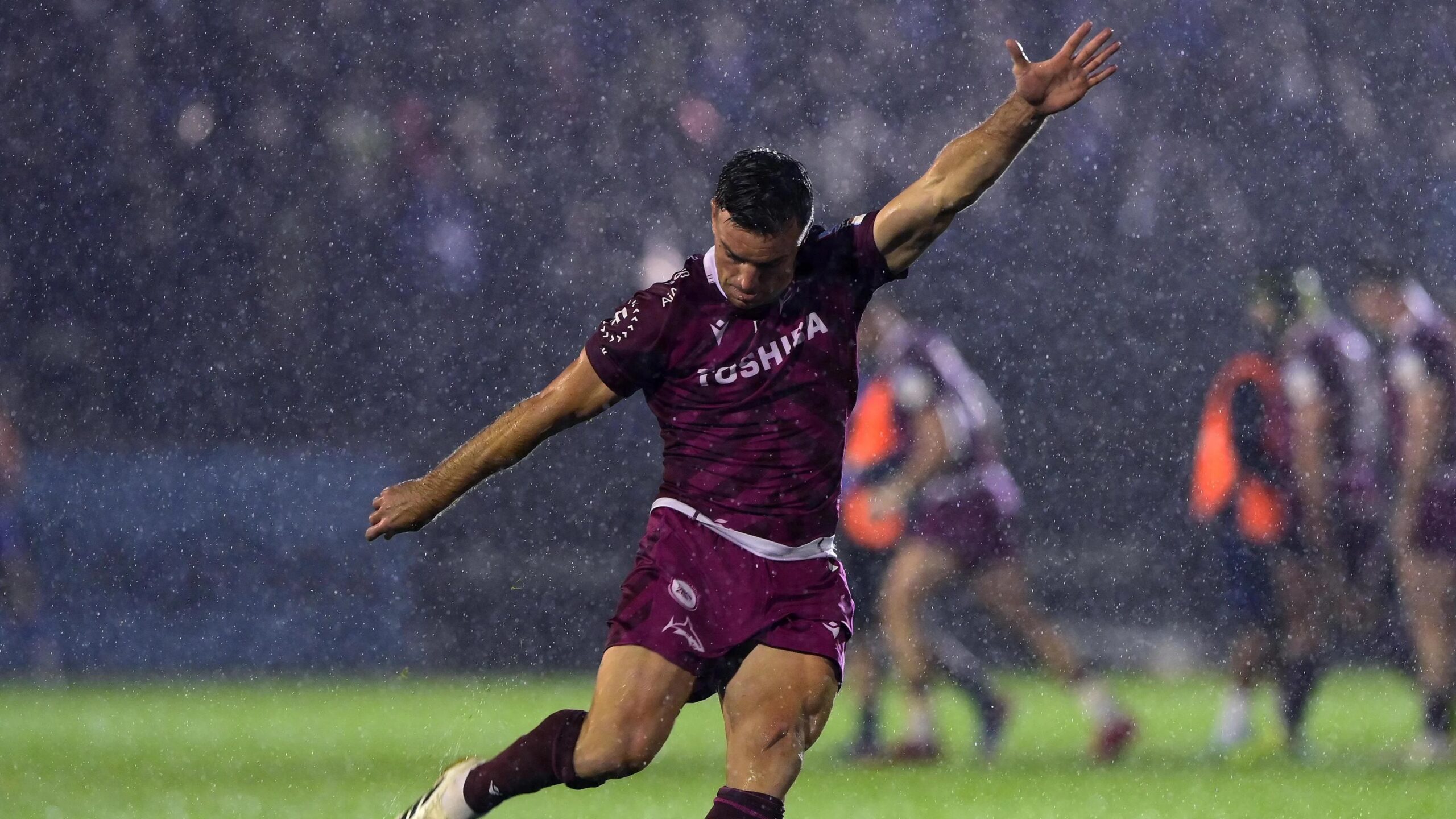 George Ford holds his arms out and draws his leg back to kick a penalty