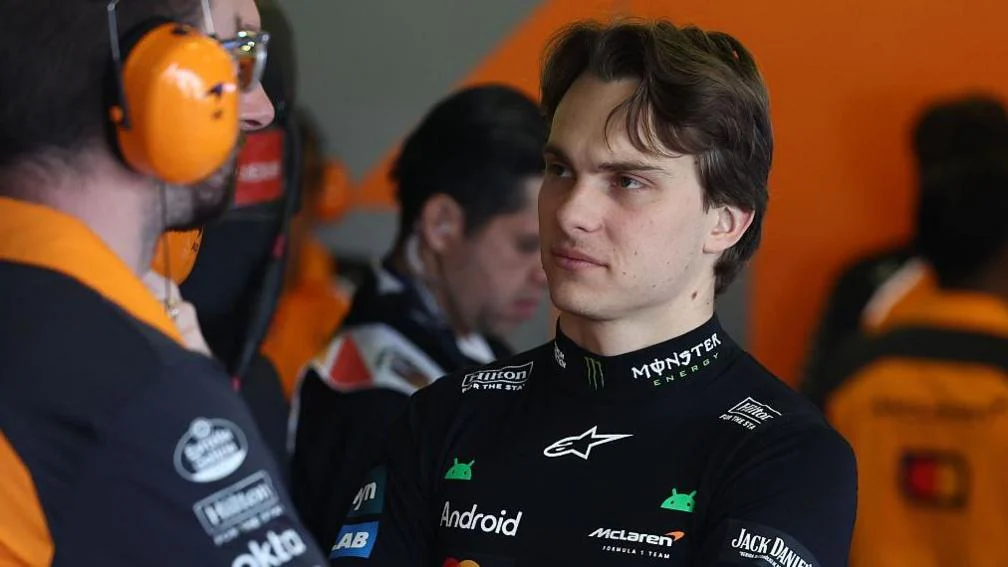 McLaren driver Oscar Piastri listening to a McLaren engineer within the team's garage at the Mexico City Grand Prix